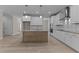 Modern kitchen with a wooden center island, white cabinets, and stainless steel appliances and granite countertops at 35 Arbor Dr, Youngsville, NC 27596