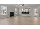 Spacious living room with hardwood floors, fireplace, and large windows at 35 Arbor Dr, Youngsville, NC 27596