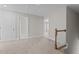Upstairs hallway with carpet, access to bedrooms and bathroom at 35 Arbor Dr, Youngsville, NC 27596