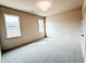 Spacious carpeted bedroom featuring two windows for natural light and a neutral color scheme throughout at 505 Rossie Jones Rd Rd, Zebulon, NC 27597