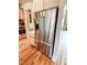 Stainless steel refrigerator that includes water dispenser, nestled among custom wood cabinets at 505 Rossie Jones Rd Rd, Zebulon, NC 27597