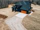 Back exterior with black siding, concrete driveway, and an oversized garage at 505 Rossie Jones Rd Rd, Zebulon, NC 27597