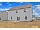 Back exterior view showcasing the newly constructed house with a small patio at 517 Southwick Pl, Mebane, NC 27302