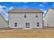 Back exterior showcasing a newly constructed home with sliding glass doors at 517 Southwick Pl, Mebane, NC 27302