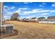 Large backyard with newly laid sod and other homes in the distance at 517 Southwick Pl, Mebane, NC 27302