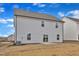 Backyard view of newly constructed house with sod and a partial lawn at 517 Southwick Pl, Mebane, NC 27302