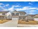 A traditionally styled home with a two car garage, a gray and stone facade, and professionally landscaped lawn at 517 Southwick Pl, Mebane, NC 27302