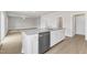 Kitchen island with stainless steel dishwasher and sink, perfect for food preparation and casual dining at 517 Southwick Pl, Mebane, NC 27302