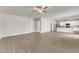 Spacious living area featuring light-colored flooring, a ceiling fan and kitchen views at 517 Southwick Pl, Mebane, NC 27302