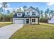 Two story white house with black accents and attached garage at 6935 Old Jefferson Davis Hwy, Cameron, NC 28326