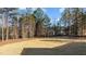 Large backyard with cleared area and pine trees at 75 Arbor Dr, Youngsville, NC 27596