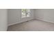 Bright bedroom with neutral carpeting and a window at 75 Arbor Dr, Youngsville, NC 27596