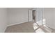 Well-lit bedroom with carpet flooring and doors to hallway and stairs at 75 Arbor Dr, Youngsville, NC 27596