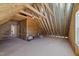 Unfinished bonus room with exposed beams and framing at 75 Arbor Dr, Youngsville, NC 27596