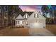 Two-story house with gray siding, white garage door, and landscaping at 75 Arbor Dr, Youngsville, NC 27596
