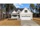 Two-story house with gray siding, white garage door, and landscaping at 75 Arbor Dr, Youngsville, NC 27596