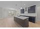 Modern kitchen with dark cabinetry, white countertops, and island at 75 Arbor Dr, Youngsville, NC 27596