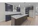 Modern kitchen with dark cabinetry, white countertops, and island at 75 Arbor Dr, Youngsville, NC 27596