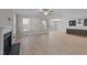 Open living room and kitchen with hardwood floors and fireplace at 75 Arbor Dr, Youngsville, NC 27596