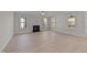Spacious living room with hardwood floors, fireplace, and large windows at 75 Arbor Dr, Youngsville, NC 27596