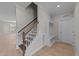 Wooden staircase with white railing and built-in bench at 75 Arbor Dr, Youngsville, NC 27596