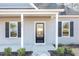 House exterior featuring a modern front door and gray siding at 929 Micro W Rd, Selma, NC 27576