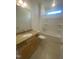 Clean bathroom with granite countertop and bathtub at 110 Sawtooth Oak Ln, Youngsville, NC 27596