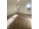 Bright bedroom with carpet flooring and large windows at 110 Sawtooth Oak Ln, Youngsville, NC 27596