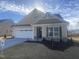 New construction home with attractive light beige exterior and two-car garage at 110 Sawtooth Oak Ln, Youngsville, NC 27596