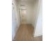 Light-filled hallway with wood flooring and laundry access at 110 Sawtooth Oak Ln, Youngsville, NC 27596