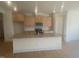 Modern kitchen with granite island and light wood cabinets at 110 Sawtooth Oak Ln, Youngsville, NC 27596