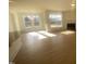 Sunlit living area with hardwood floors and fireplace at 110 Sawtooth Oak Ln, Youngsville, NC 27596