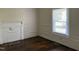 Bedroom with hardwood floors, a decorative fireplace, and a bright window that creates a light-filled and inviting space at 1200 Carolina St, Graham, NC 27253