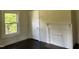 Cozy bedroom with hardwood floors, a decorative fireplace, and ample natural light from a window, creating a serene atmosphere at 1200 Carolina St, Graham, NC 27253