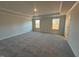 Large bedroom with carpet, neutral walls and two windows at 30 Calabria Ct, Franklinton, NC 27525
