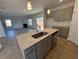 Modern kitchen with gray cabinets, granite countertops and island at 30 Calabria Ct, Franklinton, NC 27525