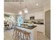 Open kitchen with island, white cabinets, and granite countertops at 30 Calabria Ct, Franklinton, NC 27525