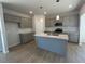 Modern kitchen with gray cabinets, granite countertops, and an island at 30 Calabria Ct, Franklinton, NC 27525