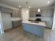 Modern kitchen with gray cabinets, granite countertops, and an island at 30 Calabria Ct, Franklinton, NC 27525