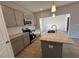 Modern kitchen with gray cabinets, granite countertops and island at 30 Calabria Ct, Franklinton, NC 27525