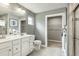 Double vanity bathroom with white cabinets, gray walls, and a walk-in shower at 600 Mathiola Dr, Wendell, NC 27591
