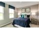 Bedroom with a full-size bed, blue and green accents, and two nightstands at 600 Mathiola Dr, Wendell, NC 27591
