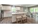 Modern kitchen with white cabinets, island, and dining area at 600 Mathiola Dr, Wendell, NC 27591