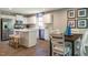 Modern kitchen with white cabinets, island, and dining area at 600 Mathiola Dr, Wendell, NC 27591