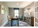 Bright home office with a large desk, comfortable chair, and built-in shelving at 600 Mathiola Dr, Wendell, NC 27591