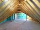 Spacious unfinished attic with wood beams and framing, offering potential for customization at 7575 Sweetwater Dr, Nashville, NC 27856