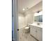 Clean bathroom with white vanity, updated fixtures, white tub, and elegant marble-like tile at 7575 Sweetwater Dr, Nashville, NC 27856