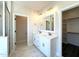 Bathroom with double sinks and a well-organized closet nearby at 7575 Sweetwater Dr, Nashville, NC 27856