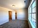 Cozy bedroom with neutral carpet, light fixture and a large window with natural light at 7575 Sweetwater Dr, Nashville, NC 27856