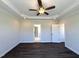 A spacious bedroom featuring hardwood floors, a ceiling fan, and elegant molding accents at 7575 Sweetwater Dr, Nashville, NC 27856